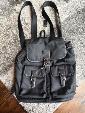 COACH
Black Nylon Backpack with Buckle-Front Pockets